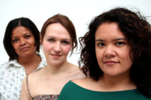 Portrait of three diverse women who are staring at the camera, serious and confident.