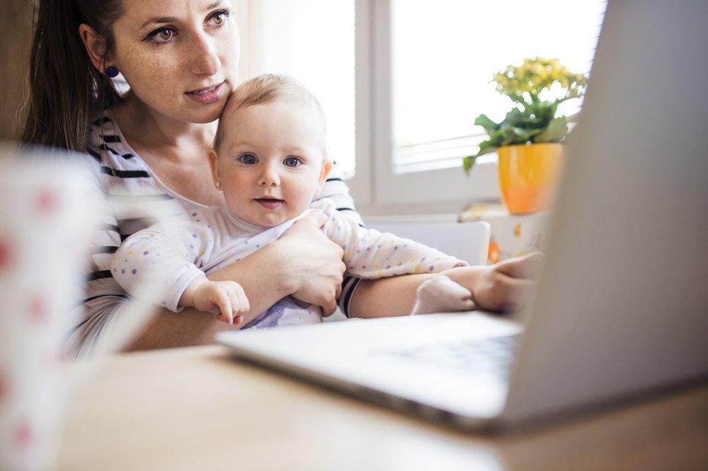 Woman Telecommuting – Working From Home Taking Care of Baby